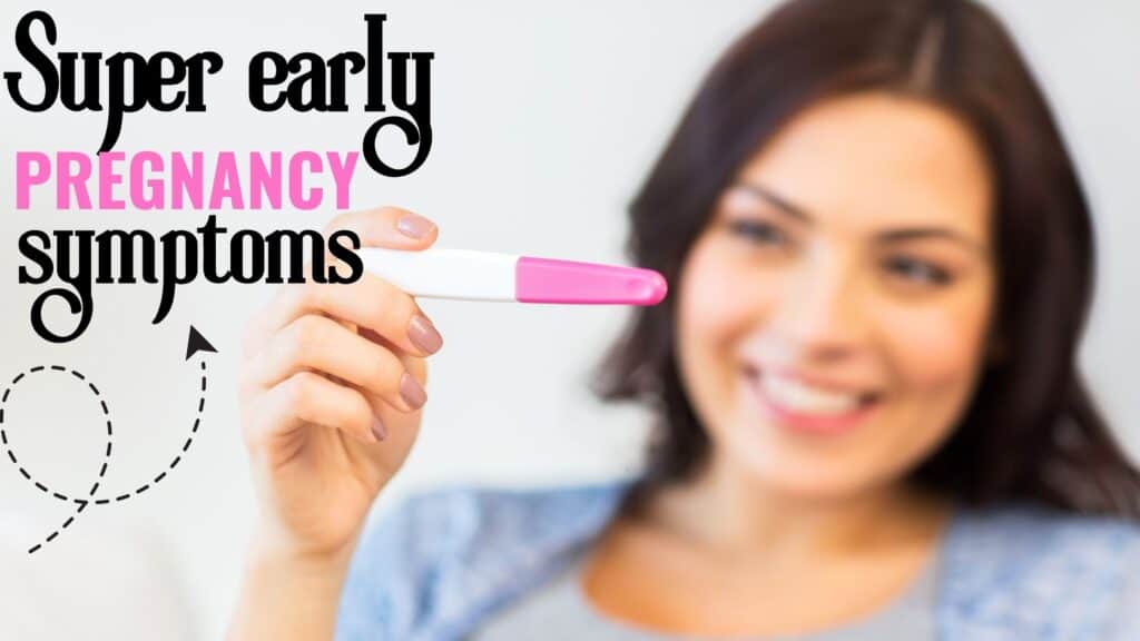 a woman holding up a pregnancy test stick that's positive and having early pregnancy symptoms